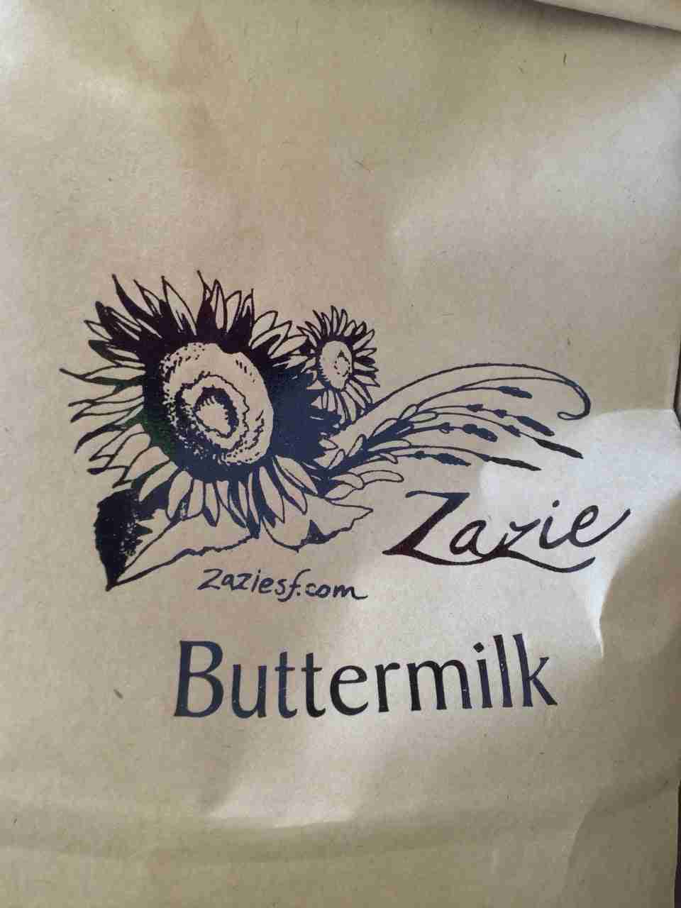 Bag of Zazie buttermilk pancake mix, with a stylized black & white graphic of sunflowers, Zazie, website, and Buttermilk text on the bag.