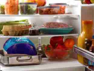 Open refrigerator with miscellaneous food items